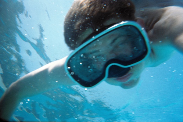 Underwater photo of boy wearing a scuba mask